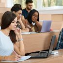 Young student working with a laptop in the university.