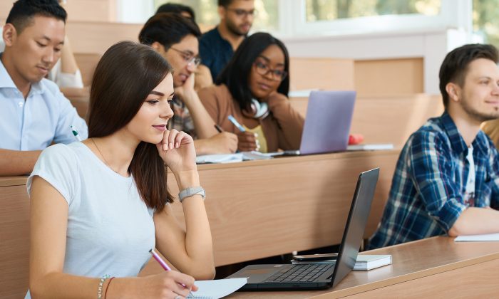 Young student working with a laptop in the university.