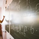 portrait-teacher-writing-on-chalkboard