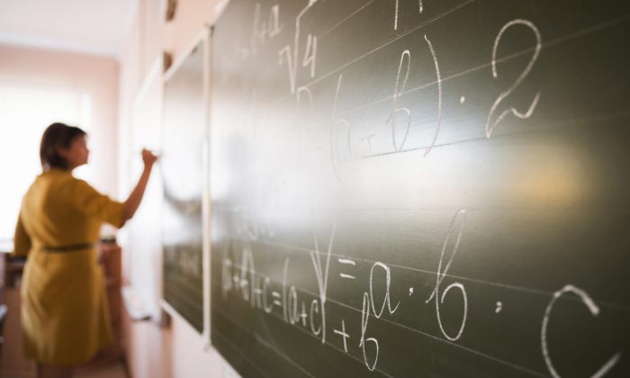 portrait-teacher-writing-on-chalkboard