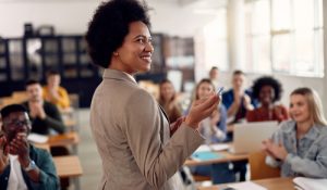 Happy,African,American,Professor,Receives,Applause,From,Her,Students,While