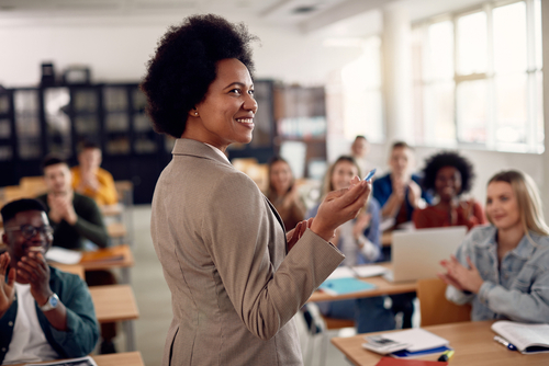 Happy,African,American,Professor,Receives,Applause,From,Her,Students,While