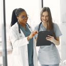 Two female doctors looking at an document