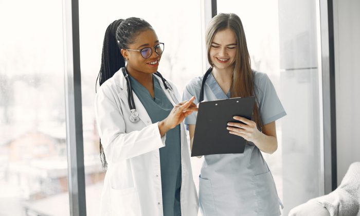 Two female doctors looking at an document